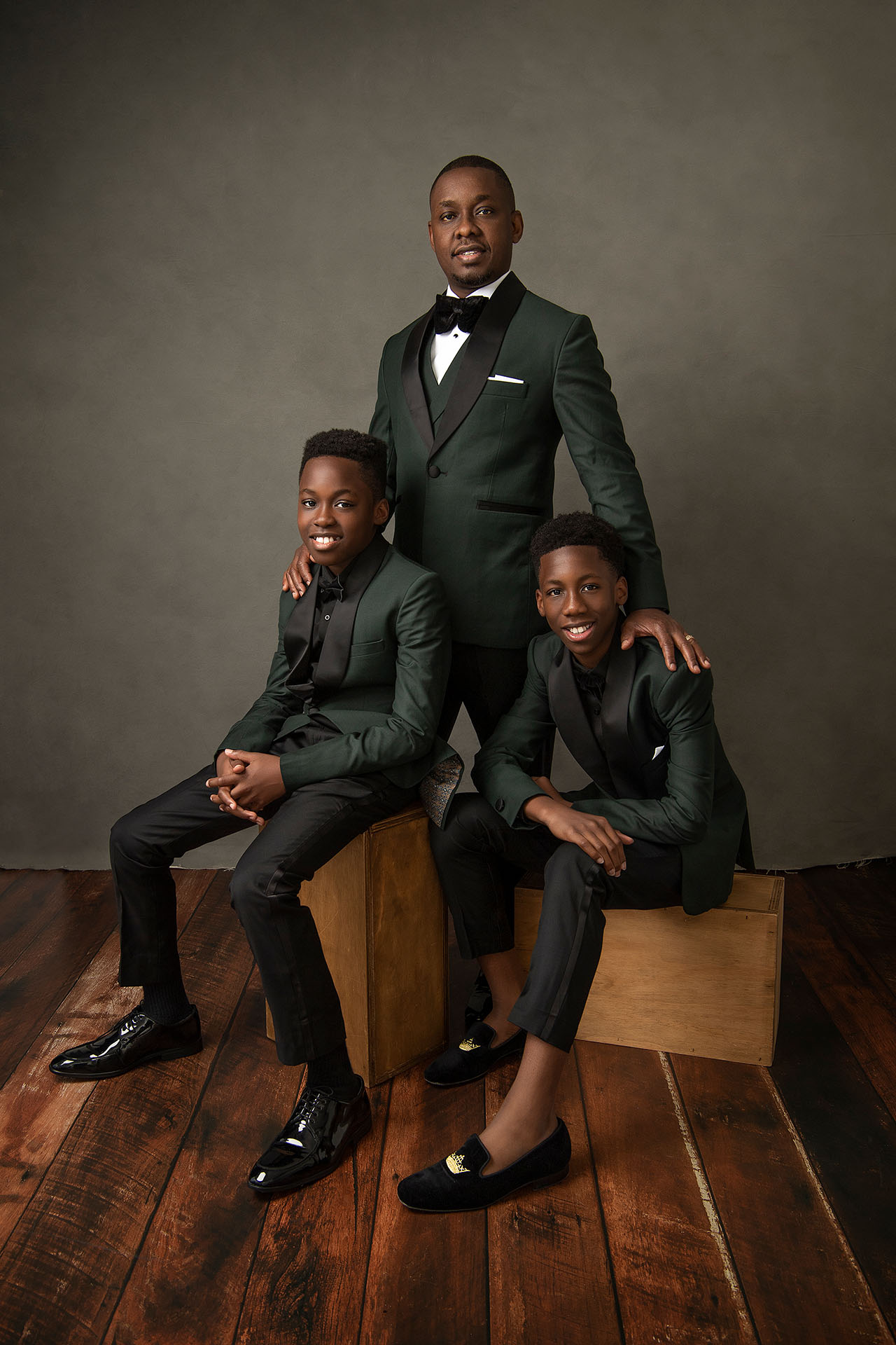 Melbourne portrait photographer Nigerian man with his sons wearing dark green suits by Robert Cavalli and Gucci shoes